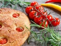 Focaccia with cherry tomatoes, fresh rosemary, peperone, selective focus Royalty Free Stock Photo
