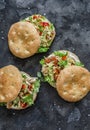 Focaccia sandwich with green salad, grilled chicken, avocado tomato salsa and yogurt sauce on dark background, top view Royalty Free Stock Photo