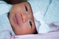 Focus at Asian baby girl with gray hat while sleeping and playing on the bed / Close up at cute newborn is looking at camera