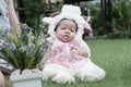 Focus at Asian newborn baby girl with costumes little sheep in the garden and mother is holding her. Royalty Free Stock Photo