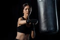 Focus of attractive girl working out near punching bag isolated on black Royalty Free Stock Photo