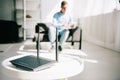 Focus of black plugged router on white table and businessman sitting on sofa Royalty Free Stock Photo