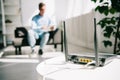 Focus of black plugged router on white table and businessman sitting on sofa Royalty Free Stock Photo
