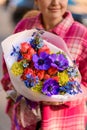 Focus on bouquet of various pink, purple and blue flowers in white matte wrapping paper Royalty Free Stock Photo