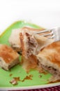 Focus on a burek on the fork with burek in the background Royalty Free Stock Photo
