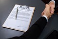 Focus business contract paper with blur background of handshake. Fervent Royalty Free Stock Photo