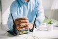 Focus of businessman holding wire with connector near router