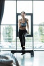 Focus of cheerful girl working out on step platform in sports center Royalty Free Stock Photo