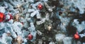 Focus on the Christmas tree in the center of the image. Red bauble and gold bauble hanging from a decorated Christmas tree. Retro Royalty Free Stock Photo