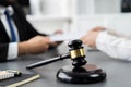 Focus closeup wooden gavel on blur background of legal team. Equilibrium