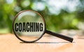 Focus on coaching - photo with magnifying glass. Personal development concept Royalty Free Stock Photo