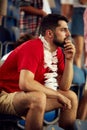 Focus on concentrated young man on stadium, attending football match to cheer up favourite team Royalty Free Stock Photo