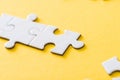Focus of connected white puzzle pieces on yellow