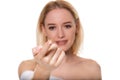 Focus on contact lens on finger of young woman. Young woman holding contact lens on finger in front of her face. Woman Royalty Free Stock Photo