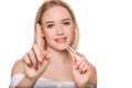 Focus on contact lens on finger of young woman. Young woman holding contact lens on finger in front of her face. Woman Royalty Free Stock Photo