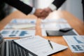 Focus contract paper with blur background of handshake and BI papers. Fervent Royalty Free Stock Photo
