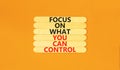 Focus on control symbol. Concept words Focus on what you can control on wooden stick. Beautiful orange table orange background. Royalty Free Stock Photo