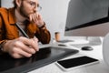 Focus of 3d visualizer using graphics tablet near computers and smartphone on table