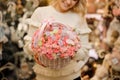 Focus on delicate white wicker basket with small pink roses inside in hands of woman Royalty Free Stock Photo