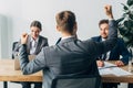 Focus of employee showing yes gesture near recruiters at table