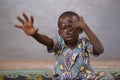 Focus on Face, defocused image of sad African Boy Posing in despair