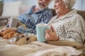 Pleased husband and wife sitting in bed