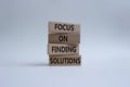 Focus on finding solutions symbol. Concept words Focus on finding solutions on wooden blocks. Beautiful white background. Business Royalty Free Stock Photo