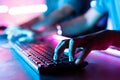 Focus on fingers, Close up shot of online professional gamer hands hitting keyboard in fast while playing at game in tournament