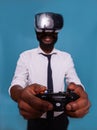 Focus on gamer hands holding gaming console controller while wearing virtual reality goggles Royalty Free Stock Photo