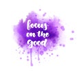 Focus on the good - handwritten modern watercolor calligraphy lettering text. Purple colored watercolor paint splash