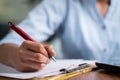 Focus on hand, Close up unrecognizable hands of Young business woman writing down notes at working desk - concept of employee or Royalty Free Stock Photo