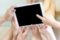 Hand three young woman holding digital tablet up over their heads with blank screen while lying on the bed Royalty Free Stock Photo