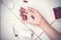 Focus on hand women after eaten pills overdose.