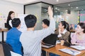 Focus on hand of young man having question in group brainstorm meeting in office.Businesspeople discussing with paperwork for Royalty Free Stock Photo