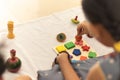 Focus on hands of cute little child girl playing with Indian wooden channapatna toys in the room Royalty Free Stock Photo