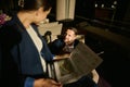 Focus on a handsome Caucasian businessman looking at his blurred female business partner, sitting in front of him and reading Royalty Free Stock Photo