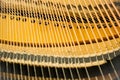 Focus inside of grand piano, show piano strings that make music sound key.