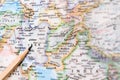 Focus on IRAN on the world map with pencil pointing