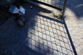 Focus of the iron fence shadow with grid pattern on the floor. Royalty Free Stock Photo