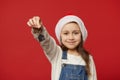 Focus on keychain in hands of a delightful baby girl in Santa hat holding out keys of new house, residence. Real estate