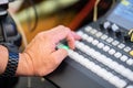 Focus on man`s hand how control the livestreaming switcher board