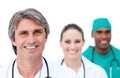 Focus on a mature doctor in front of his team Royalty Free Stock Photo