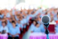 Microphone over the blurred business conference hall or seminar room, Blurred background.