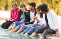 Focus on middle boy, Group of young millenials having fun and enjoying some good time near swimming pool - Concept of friendship, Royalty Free Stock Photo