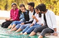 Focus on middle boy, Group of young millenials having fun and enjoying some good time near swimming pool - Concept of friendship,