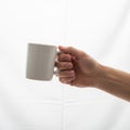 Focus is on the mug and the manner in which it is held with no Royalty Free Stock Photo