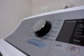 Angled, selective focus on a new, high end clothes washing machine knob control panel, with a variety of wash settings Royalty Free Stock Photo