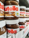 Focus on Nutella jars of hazelnut cream in french supermaket shelf. Nutella is a brand of products made in Italy by Ferrero