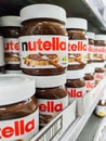 Focus on Nutella jars of hazelnut cream in french supermaket shelf. Nutella is a brand of products made in Italy by Ferrero