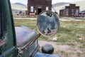 Focus on an old classic rearview mirror on a classic jalopy truck, abandoned in the Bodie Ghost Town in California